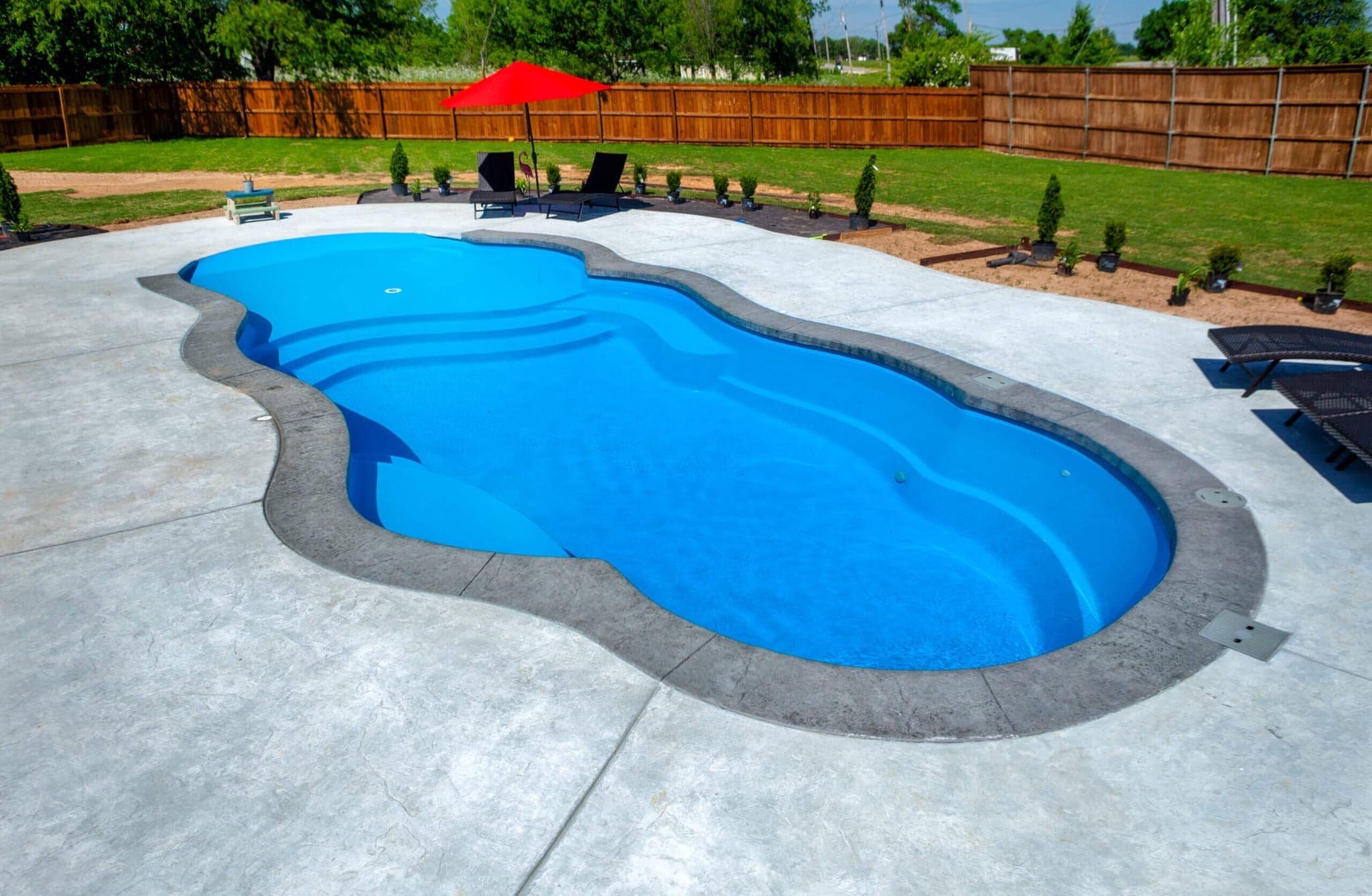 Sandal beach entry fiberglass pool with ledge loungers