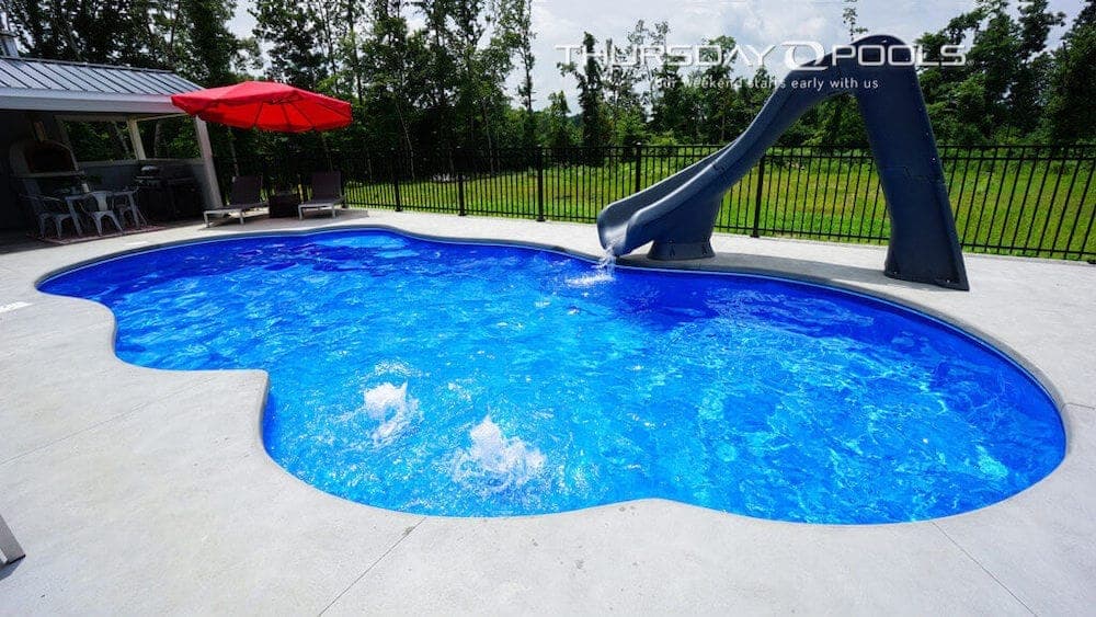 Sun Day freeform fiberglass pool installed with landscaping