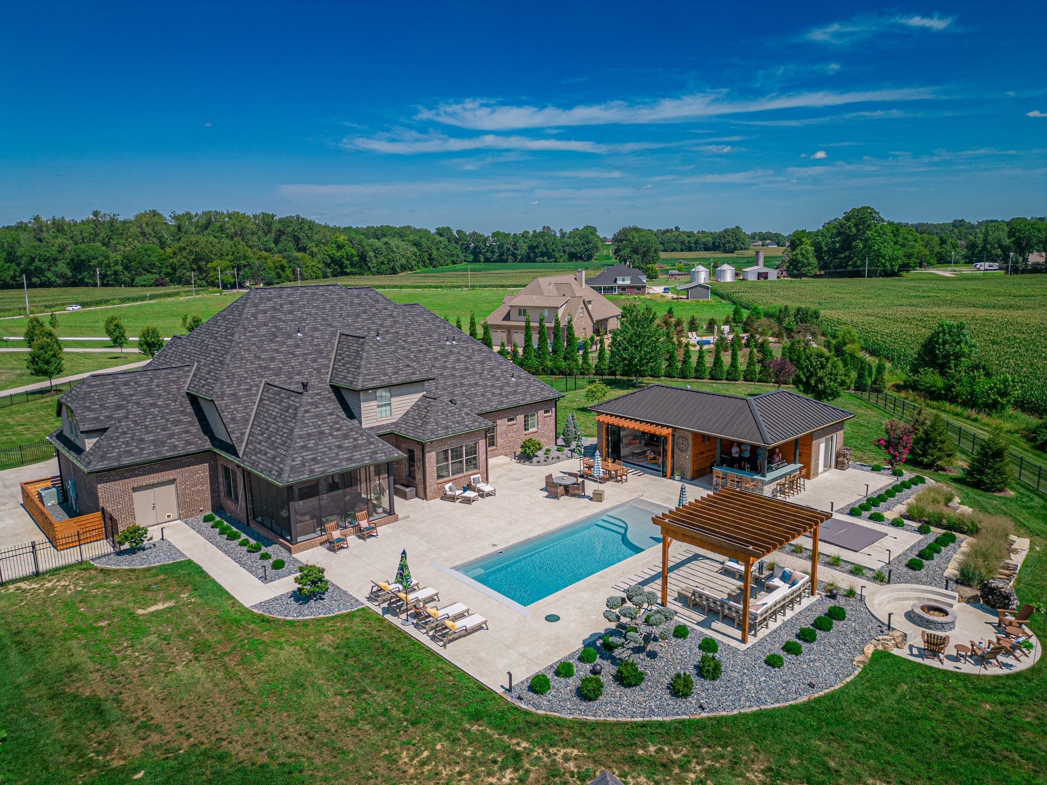 Aerial view of complete backyard transformation with pool and pergola