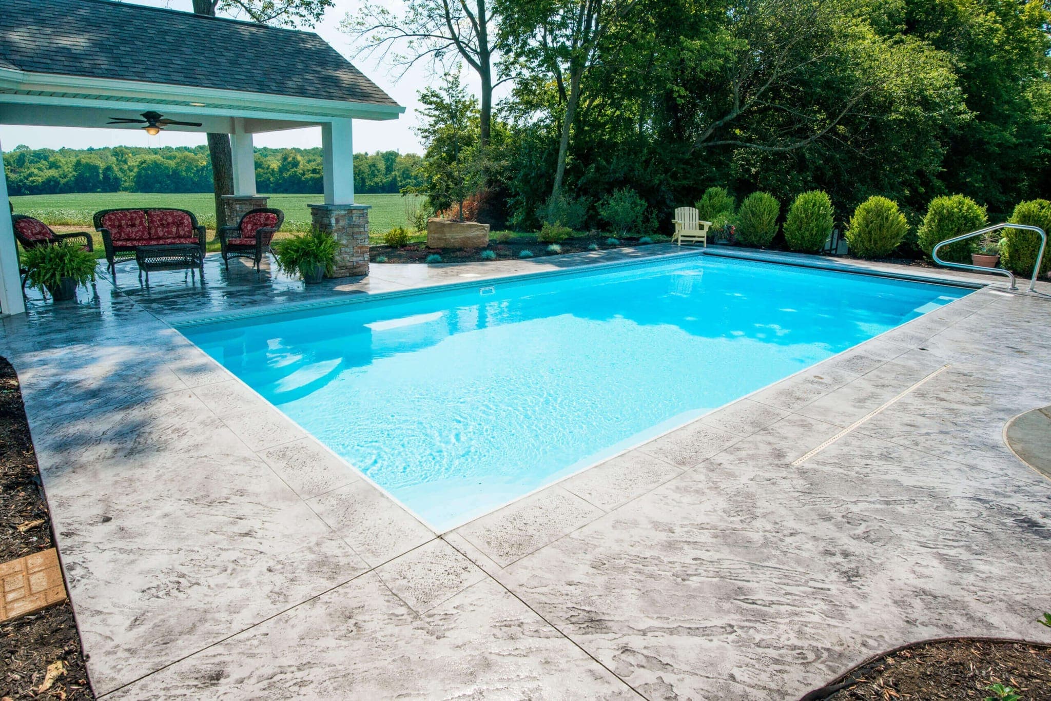 Goliath rectangular fiberglass pool installed with patio and landscaping