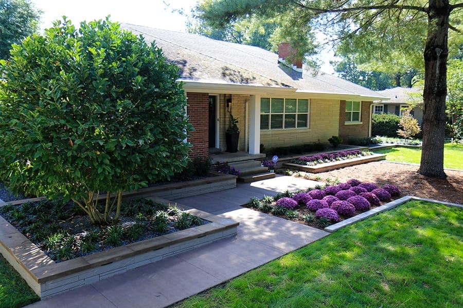 Custom landscape design with layered plantings and stone features