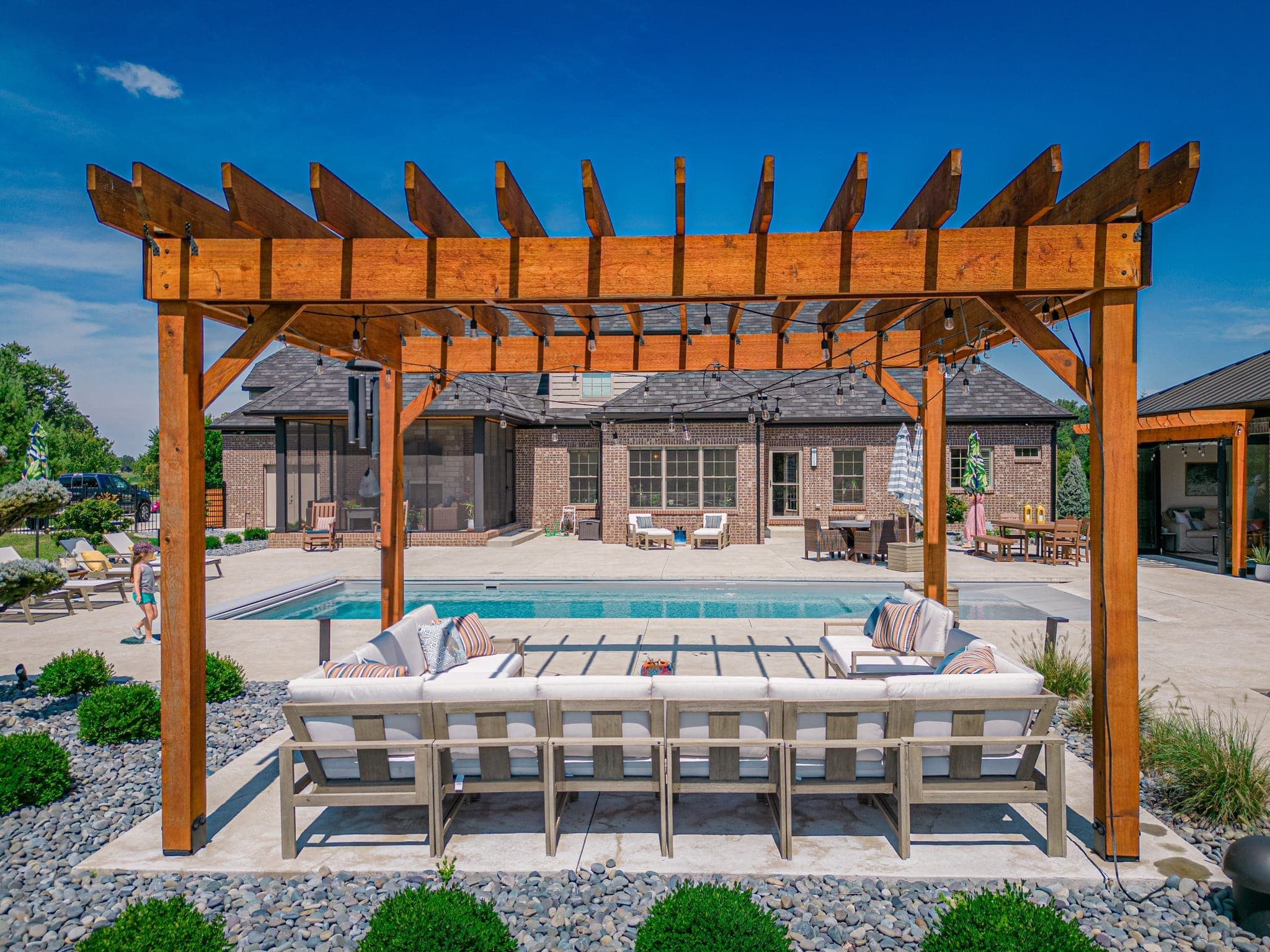 Pool with custom pergola providing shaded lounging area