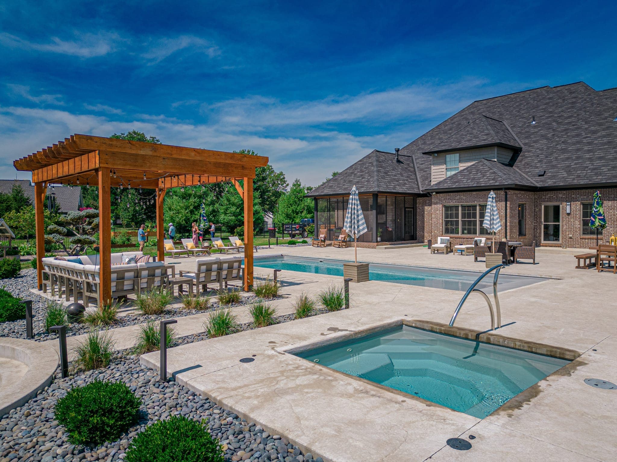 Custom pool and spa with stone coping and landscape plantings