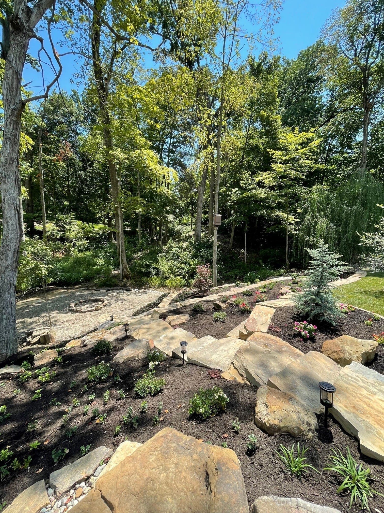 Custom stone steps with landscape lighting and plantings